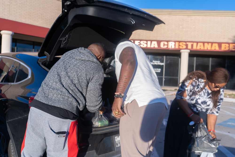 Volunteers preparing food packages for distribution